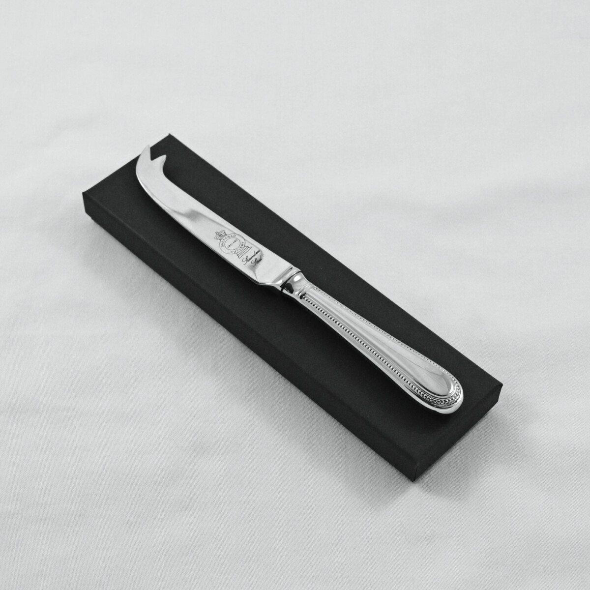 A Bead Pattern Stainless Steel Cheese Knife Gift Boxed And Engraved 'Sheffield, England'