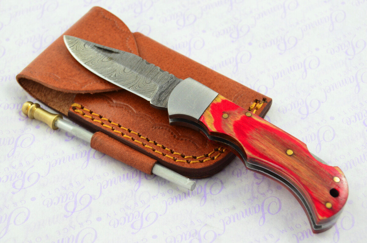 A Handmade Damascus Steel Pocket Knife - Red & Cream Laminate Wood Scales
