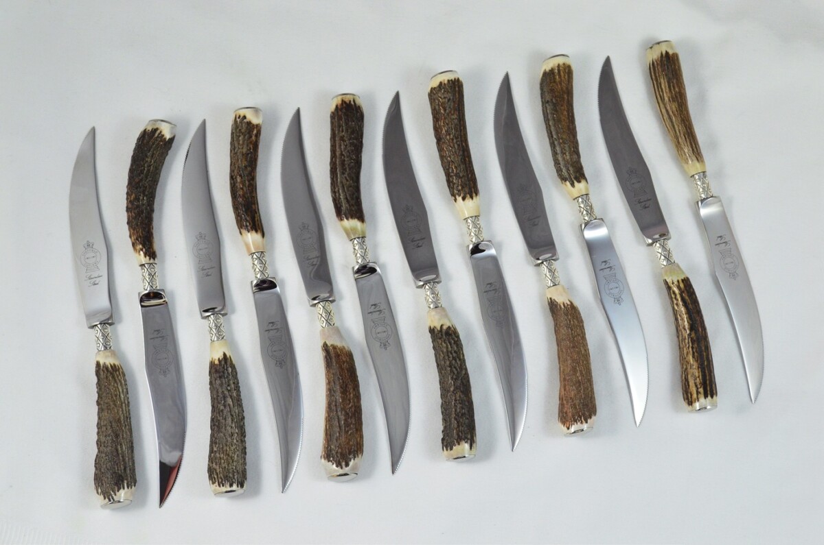 A Set of 12 Sheffield Silver Ferruled Steak Knives with Red Deer Stag Antler Handles